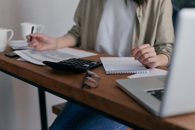 Person working out cost on laptop